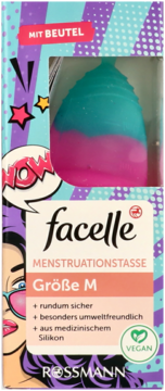 Facelle menstrual cup M in blue and pink, visible in a colorful pop art box with a 'MIT BEUTEL' label.