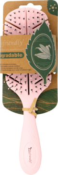Różowa biodegradowalna szczotka do włosów na brązowym opakowaniu z zielonym liściem i napisem 'eco friendly', widok z przodu.