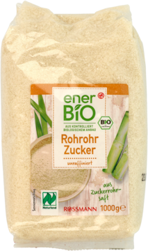 Przezroczysta torebka cukru trzcinowego enerBiO Rohrohr Zucker 1000g, widoczny jasnobrązowy cukier, zielono-pomarańczowa etykieta.