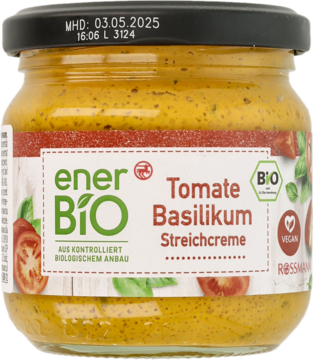 Słoik enerBIO Pasta pomidorowo-bazyliowa, żółto-pomarańczowa, z zieloną etykietą i czarną nakrętką, widok z przodu.