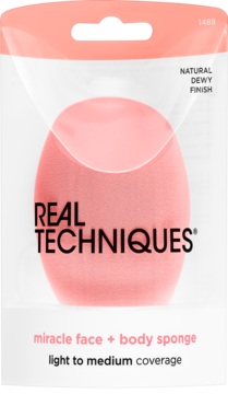 Różowa gąbka Real Techniques Miracle Face + Body Sponge w przezroczystym opakowaniu, naturalny dewy finish, widok z przodu.