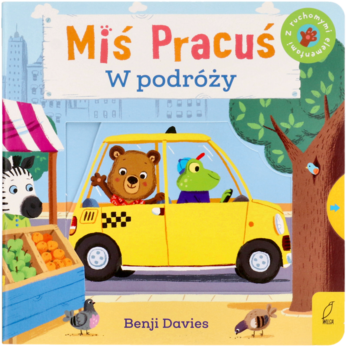 Książka Miś Pracuś W podróży, okładka z misiem, krokodylem w żółtej taksówce w mieście, twarde strony.