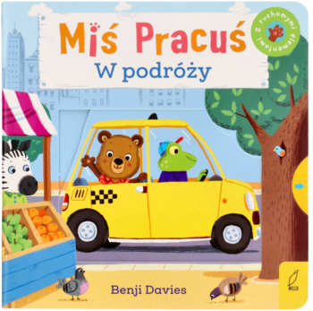Książka Miś Pracuś W podróży, okładka z misiem, krokodylem w żółtej taksówce w mieście, twarde strony.