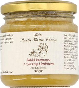 Kremowy miód z cytryną i imbirem Pasieka Słodka Kraina w szklanym słoiku ze złotą nakrętką, widok z przodu.