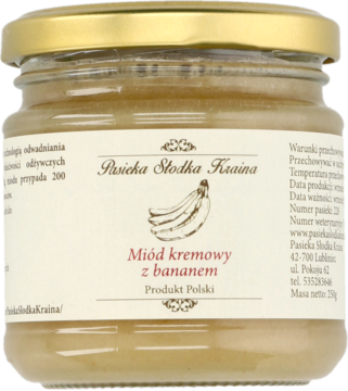 Kremowy miód z bananem Pasieka Słodka Kraina, słoik 250g, jasny kolor, złota zakrętka, z przodu etykieta z bananami.