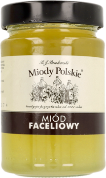 Słoik bladożółtego miodu faceliowego B.J. Pawłowski Miody Polskie, z czarną nakrętką, etykietą z ulami, widok z przodu.