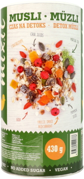 Cylindryczne opakowanie Musli Müzli Detox 430g, zielono-białe, z grafiką składników i tekstem "Vegan, No Added Sugar".