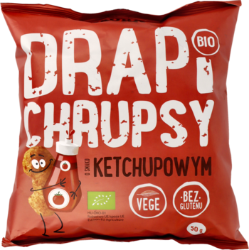 Czerwone opakowanie chrupek DRAPI CHRUPSY BIO ketchupowych, z wesołą postacią i etykietami VEGE, BEZ GLUTENU.