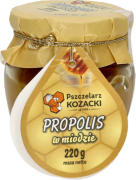 Szklany słoik miodu z propolisem Pszczelarz Kozacki 220g, ze złotą zakrętką i etykietą w kształcie kropli, przód.