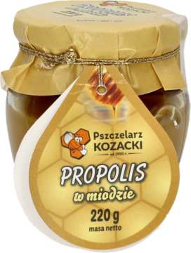 Szklany słoik miodu z propolisem Pszczelarz Kozacki 220g, ze złotą zakrętką i etykietą w kształcie kropli, przód.
