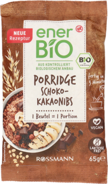 Brązowe opakowanie enerBio Porridge Schoko-Kakaonibs 65g, wegańska, bez laktozy, z miską owsianki i kakao.