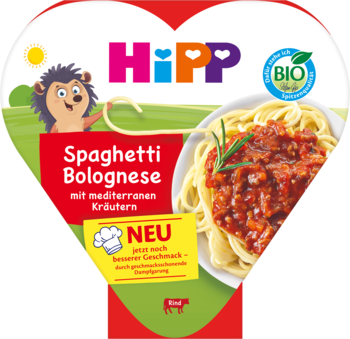 HiPP BIO Spaghetti Bolognese dla dzieci po 1. roku, z banerem "NEU", miska z makaronem i jeżem na tle zielono-czerwonym.