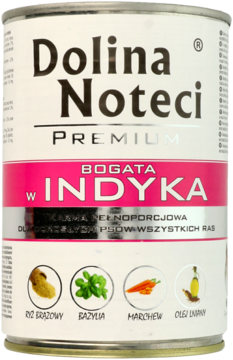 Puszka karmy Dolina Noteci Premium dla psa, z etykietą biało-różową, napisem "bogata w indyka" i ikonami składników.