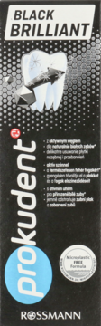 Prokudent Black Brilliant, czarna pasta do zębów z aktywnym węglem, opakowanie z przodu, grafika zęba i pyłu.
