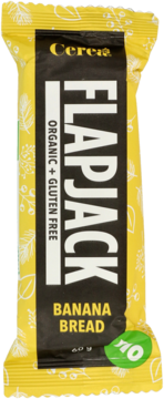 Ekologiczny baton Flapjack Banana Bread Cerea, organiczny i bezglutenowy, w żółto-czarnym opakowaniu, widok z przodu.