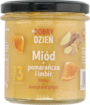 Słoik miodu Dobry Dzień z pomarańczą i imbirem, kremowa zawartość, czarna nakrętka, widok z przodu.