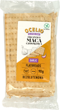 Ocelio Pieczywo Maca czosnkowa, bezglutenowe, wegańskie. Opakowanie z pomarańczową etykietą, widok z przodu.