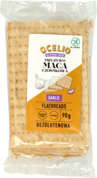 Ocelio Pieczywo Maca czosnkowa, bezglutenowe, wegańskie. Opakowanie z pomarańczową etykietą, widok z przodu.