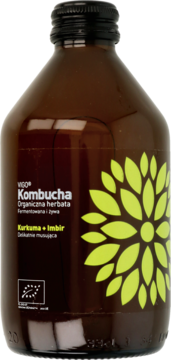 Brązowa butelka VIGO Kombucha Kurkuma+Imbir, z czarną nakrętką i etykietą z dużym żółto-zielonym kwiatem. Widok z przodu.