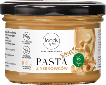Frontowy widok słoika kremowej pasty z nerkowców Foods by Ann, z czarną zakrętką, z logo Vegan i orzechami na etykiecie.