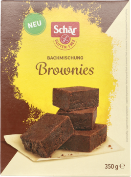 Brązowo-żółte opakowanie Schär, bezglutenowa mieszanka do pieczenia brownie, widok z przodu, z obrazkiem stosu ciastek.