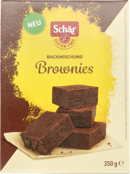 Brązowo-żółte opakowanie Schär, bezglutenowa mieszanka do pieczenia brownie, widok z przodu, z obrazkiem stosu ciastek.