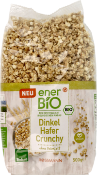 Przezroczysta torebka enerBio Dinkel Hafer Crunchy, widoczne chrupiące kawałki, logo Bioland i VEGAN.
