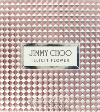 Zbliżenie na wieczko perfum Jimmy Choo Illicit Flower. Różowo-złote, fakturowane, z metalicznym napisem.