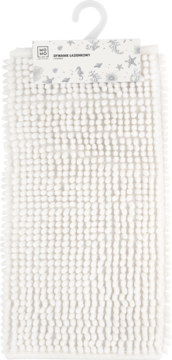 Biały dywanik łazienkowy 40x60 cm z mikrofibry, wiszący. Widoczne wypustki i metka z logo MO MO i grafiką.