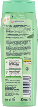 Tył zielonej butelki szamponu Isana Herbal z rumiankiem, widoczną etykietą ze składem i barkodem.