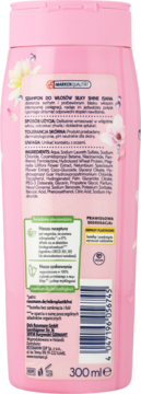 Różowa butelka szamponu ISANA Silky Shine 300ml, widok z tyłu z listą składników i kwiatami magnolii.