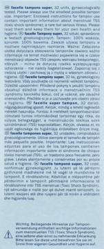 Close-up of Facelle tampons super 32 units leaflet with multilingual warning text on TSS on light blue background.