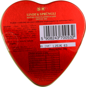 Tył czerwonej, sercowatej puszki pralinek Lindt & Sprüngli z mlecznej czekolady, z etykietą, kodem kreskowym i danymi odżywczymi.