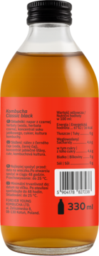Tył szklanej butelki Kombuchy Forever Young Classic Black 330ml. Czerwona etykieta z danymi i kodem EAN.