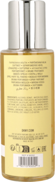 Tył butelki perfum DKNY w żółtym płynie ze srebrną nakrętką, widoczna etykieta ze składnikami.