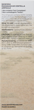 Tył beżowego opakowania ampułki SKIN1004 Madagascar Centella, z listą składników i danymi producenta.