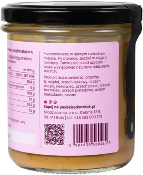 Tył szklanego słoika pasty orzechowej z fistaszków i solą himalajską, różowa etykieta, widoczny skład.