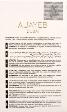 Białe opakowanie perfum AJAYEB DUBAI ze złotym logo, widoczne składniki i ostrzeżenia w wielu językach.