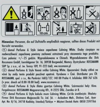 Biała etykieta świecy zapachowej Domol Calming White, z ostrzegawczymi piktogramami i tekstem.