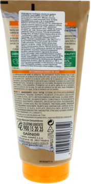 Garnier Ambre Solaire SPF 50+ nawilżające mleczko do opalania, tył beżowej tuby z opisem produktu i barcode.