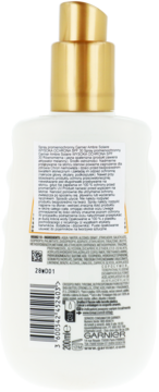 Tylna strona białej butelki sprayu ochronnego Garnier SPF 30 z pompką, widoczne opisy i kod EAN.