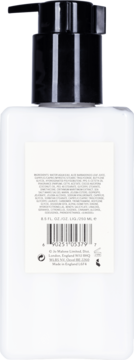 Tył białej butelki balsamu Jo Malone London Peony & Blush Suede z czarną pompką, widoczne składniki i kod.