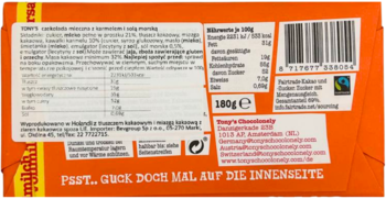 Pomarańczowy tył opakowania mlecznej czekolady Tony’s Chocolonely karmel-sól morska, z etykietą i kodem kreskowym.