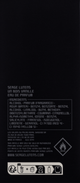 Tył opakowania perfum Serge Lutens Un Bois Vanille Eau de Parfum, czarne, z widoczną listą składników i symbolami.