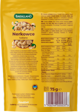 Tył żółtego opakowania orzechów nerkowców BAKALLAND NerKowce łuskane 75g, z tabelą wartości odżywczych.