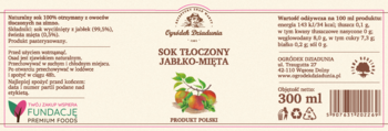 Etykieta soku tłoczonego Ogródek Dziadunia Jabłko-Mięta 300 ml, z ilustracją owoców i mięty, jasne tło.