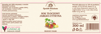Etykieta soku jabłko-cytryna Ogródek Dziadunia na różowo-beżowym tle, z grafiką owoców, widok z przodu.