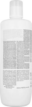 Tył białej butelki odżywki Indola Color z drobnym tekstem etykiety, białą zakrętką i adresem strony www.