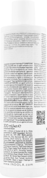Tył białej butelki szamponu Indola przeciwłupieżowego, z gęstym tekstem etykiety i kodem QR.