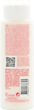 Tył białej butelki mleczka Clarins Velvet Cleansing Milk, wzbogaconego ekstraktami. Widoczne składniki, kody.